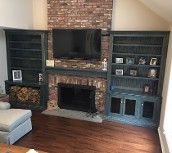 image shows a custom-built wall unit with a fireplace and television