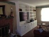 image shows a custom-built wall unit, likely an entertainment center, created by Old Bedford Fine Custom Carpentry