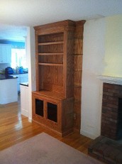 a built-in wooden cabinet, possibly an entertainment center or bookcase
