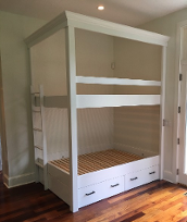 image displays a white, wooden "Twin Over Twin Built-In Bunk Bed With Pop-Up Trundle