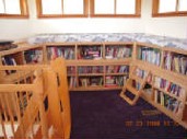 image shows a room with bookshelves and what appears to be a child's reading area