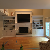 A built-in fireplace is a complete unit designed to be installed into a wall or a specially constructed surround, offering a seamless and sleek look.